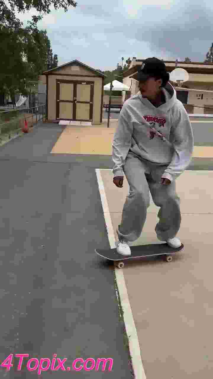 Nyjah Huston does an ollie over a big cone then hits a grind down a rail.